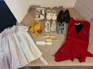 lot 1033 image: Baby shoes, leather moccasins, baby brush and combs, dress, Blue Bird vest with Campfire Girl scarf.