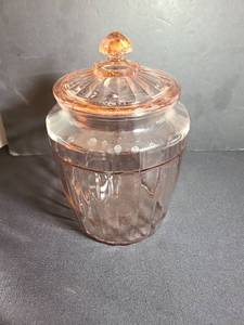 lot 1057 image: Pink Depression Glass Covered Jar with Lid and Finial, 10in tall
