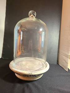 lot 1065 image: Clear glass cloche dome on distressed clay base, 15in tall
