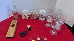 lot 1414 image: Collectible Lot Mugs, Glasses, Bottle, New Zealand wine bottle holder and more