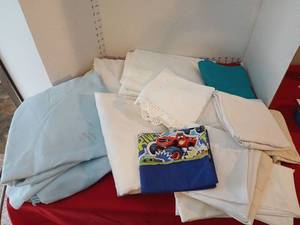lot 1710 image: Lot of linens queen top sheets and various styles of pillowcases