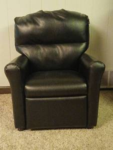 lot 2305 image: Childrens Black Upholstered Armchair  26x21 at cushion 12inches located in basement
