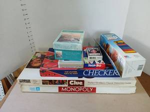 lot 3034 image: Lot of Board Games Puzzles Playing Cards Checkers Monopoly Clue Skip-Bo