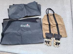 lot 3134 image: Canvas log carrier, Hypertough leather gloves, cut up Char-Broil grill cover used for firewood