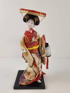 lot 123 image: Geisha Doll with Red and Gold Costume on Black Base