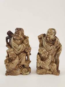 lot 133 image: Pair of Carved Figurative Statues with Decorative Motifs Stone