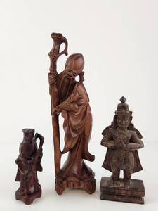 lot 139 image: Three Carved Wood Figurines Lot Asian Inspired Decorative Statues