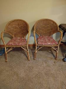 lot 939 image: 2 Wicker Chairs with Cushions.  33in tall. Seat 17 x 17. Located in basement
