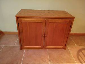 lot 943 image: Oak 2 Door Cabinet.  27 x 37 x 18.  Located in basement