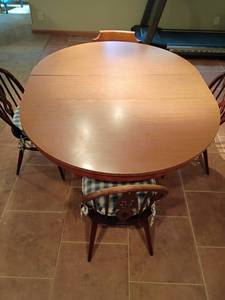 lot 945 image: Kitchen Table.  With Leaf.  30 x 48 x 60.   4 Chairs 3 are Matching.   Located in Basement. Table legs and chairs need some stain.  See pictures