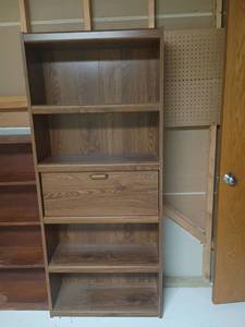 lot 993 image: Bookshelf with Middle Storage.  72 x 31 x 12.  Located in basement