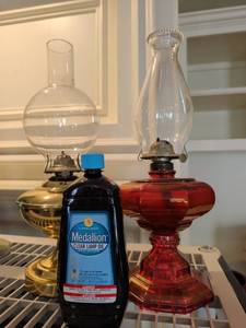 lot 1025 image: Brass and cranberry glass hurricane lamps with Medallion lamp oil