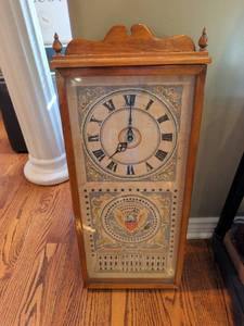 lot 1217 image: Wall Clock with cross stitch White House and Eagle Seal Design 27x12