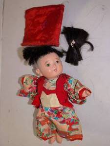 lot 1288 image: 9in Asian Doll with Black Hair Red Floral Outfit