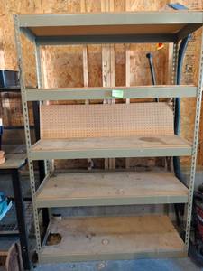 lot 3610 image: Industrial Metal Shelving Unit 4-Shelf Storage Rack 72x49x19 in garage. Currently in use. Please come toward the end of load out to remove.
