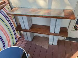 lot 4111 image: Homemade patio shelves from boards and cinder blocks with glass top, 34X48X11.