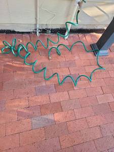 lot 4203 image: Green coil hose.