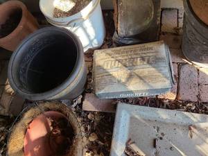 lot 4217 image: Bag of Quikrete, 5 gallon bucket of gravel, plastic pot, hanging coconut lined basket.