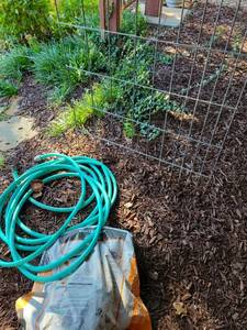 lot 4219 image: Green garden hose, wire trellis, 34x48, partial bag peat moss.