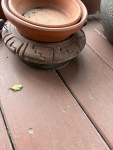 lot 4104 image: Play pot with rocks, 3x8, and 2 clay saucers.