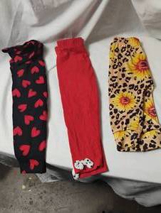 lot 35698 image: CHILDRENS black pants with red hearts size 24m, red Minnie Mouse pants size 2T, Shein sunflower pants size 12m