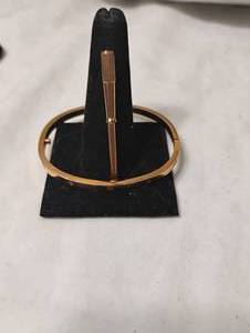 lot 35834 image: LvL 5 Replica - Gold Cartier Bracelet.