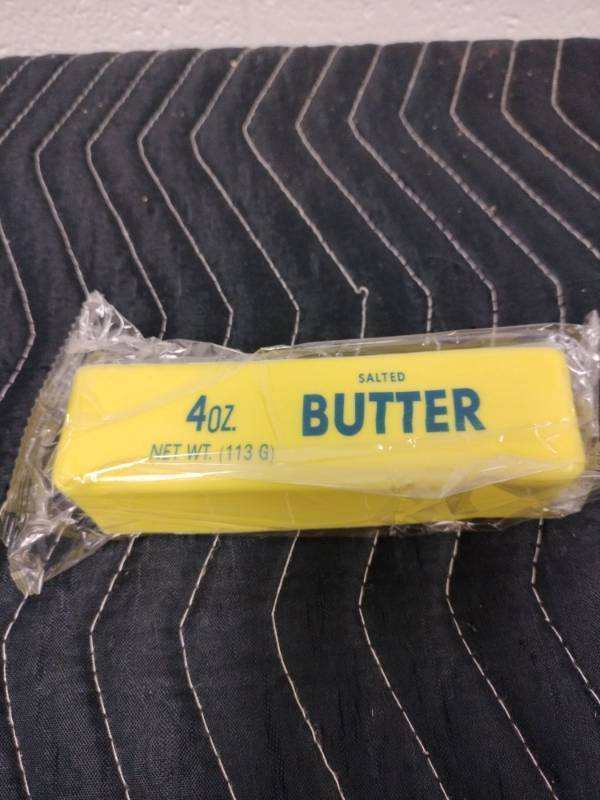 lot 91 image: Butter Squishy Toy Stick Replica 4oz Salted Butter Design