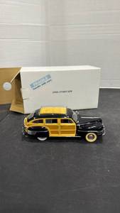lot 1059 image: 1942 Chrysler Town & Country Woody Wagon black and woodgrain scale model die cast car with a box