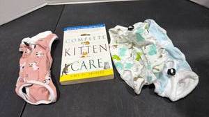 lot 2101 image: Kitten Onesies and book