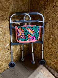 lot 2121 image: Foldable walker with quilted pouch