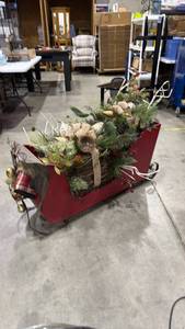 lot 2526 image: Lit wooden Christmas sleigh with twig presents and winter greenery and sleigh bells approximately 32 x 15 x 54 in