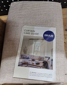 lot 17944 image: Miulee Linen-Look Curtain Panels Folded in Packaging w Care Guide