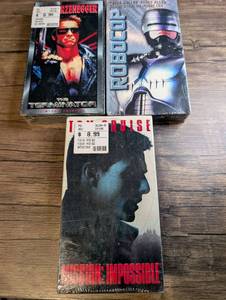 lot 1427 image: VHS Lot of 3 Sci-fi, Action &amp Thriller Tapes The Terminator, RoboCop, Mission Impossible