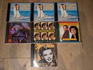 lot 1435 image: Music CD Lot of 7 including Ultimate Love Collection Discs 1-3, Kenny Loggins, Judy Garland