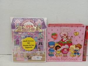 lot 13037 image: Melissa & Doug Puffy Sticker Dress-Up Set & Strawberry Shortcake Activity Book