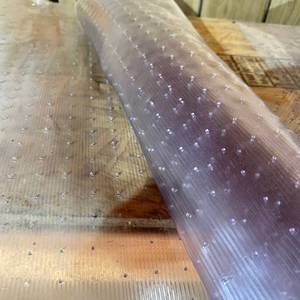 lot 11 image: Clear Textured Plastic Floor Protector Mat Roll with Studs