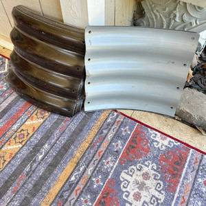 lot 88 image: Curved Corrugated Panels with Pre-Punched Holes for raised planters, Stack Lot of 18