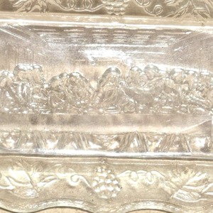 lot 135 image: Clear Glass Dish with Embossed Last Supper Scene and Grape Cluster Border