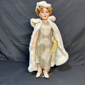 lot 204 image: Collectible Doll in Beaded Fringe Dress with White Faux Fur Cape and Hat on Stand