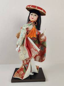 lot 107 image: Vintage Geisha Doll in Red Floral Brocade Kimono with Round Red Hat on Black Base