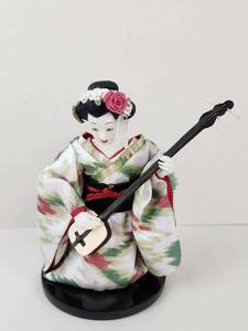 lot 110 image: Vintage Geisha Doll Kneeling Figure Doll Holding Three-Stringed Instrument on Round Black Base