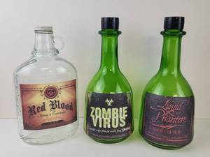 lot 312 image: Halloween Novelty Bottle Lot of 3 Red Blood 750ML, Zombie Virus, Liquid Phantom