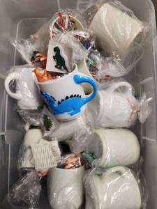 lot 315 image: Halloween Goodie Bags Dinosaur Mug with Dinosaur Figurines