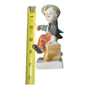 lot 103 image: Painted Ceramic Figurine Boy with Green Hat and Bag 4.5 inches