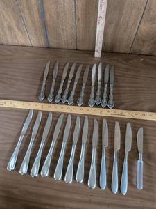 lot 112 image: Lot of 23 Table Knives Mixed Patterns Ornate and Twist Handles