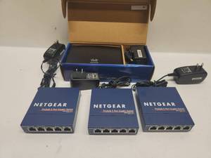 lot 31 image: Cisco Linksys SE1500 5-Port Fast Ethernet Switch with 3x Netgear ProSafe GS105 5-Port Gigabit Switches Lot