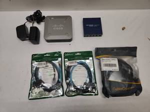 lot 55 image: Cisco SD2005 5-Port Switch, Netgear GS105v5 Switch, Cables and Accessories Lot