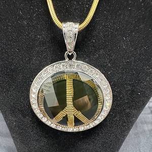 lot 23 image: NEW 3.5in Peace Sign Pendant Necklace with Clear Stone Bezel and Gold-Tone 24in Chain