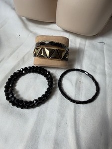 lot 36837 image: Lot of 5 Black & Gold Toned Bracelets.
