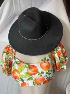 lot 36907 image: Black Cowgirl Hat Adorned With a Gold TOned Butterfly Station Chain Wrapped around The Crown.